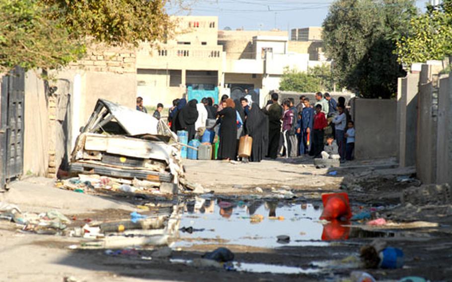 Residents collect government fuel rations in the Hadar neighborhood of southern Baghdad. Essential services are gradually being restored.