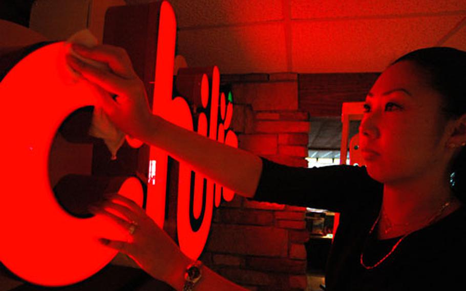 Waitress trainee Shiho Carter helps put the finishing touches on Yokosuka Naval Base’s new Chili’s restaurant. After more than six months of construction, the new restaurant, which will seat 270 patrons, opens Monday.