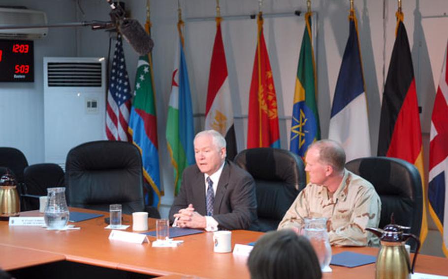 Secretary of Defense Robert M. Gates addresses the media at Camp Lemonier, the Combined Joint Task Force -Horn of Africa base in the small northeastern African nation of Djibouti on Dec. 3. Rear Admiral James M. Hart, commander of the task force, listens.