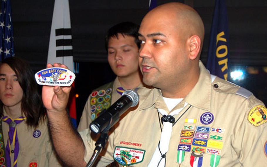 Korea District committee member and event emcee Marc Garduno prepares to present this year’s Eagle Scouts with a special Far East District shoulder patch featuring an Eagle Scout insignia at the 2nd Annual 2007 Eagle Scout Recognition Dinner on Friday at the Dragon Hill Lodge.