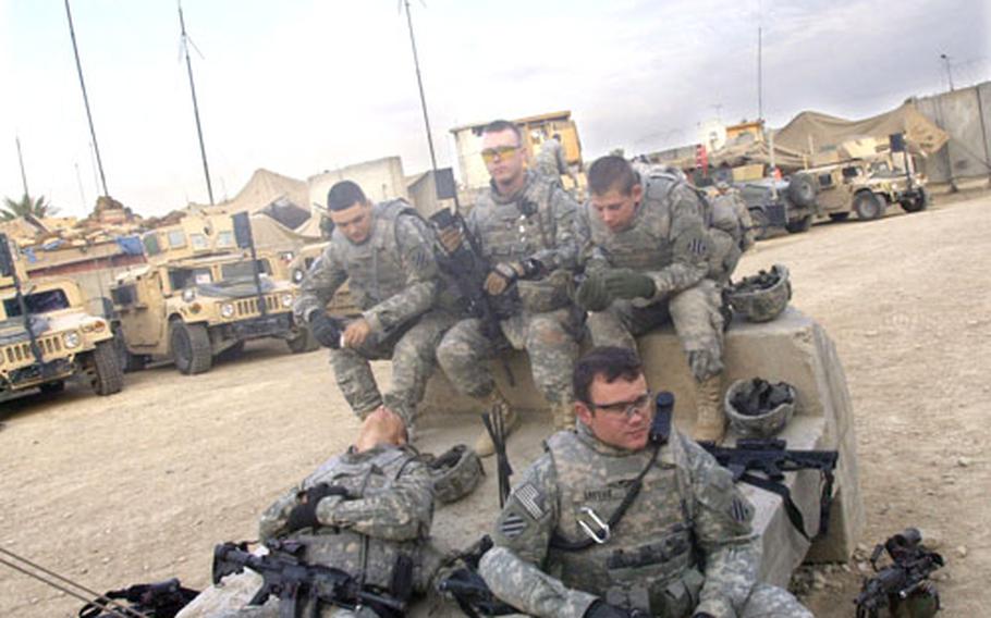Soldiers wait for their patrol to begin at Patrol Base Jurf, a bare-bones outpost in Jurf-as Sakhir, about 30 miles southwest of Baghdad. From the top, clockwise: Pfcs. Renat Tatarin, William Furgason and Billy White; Spc. Timothy Louvier, and Pfc. Daniel Thornton.