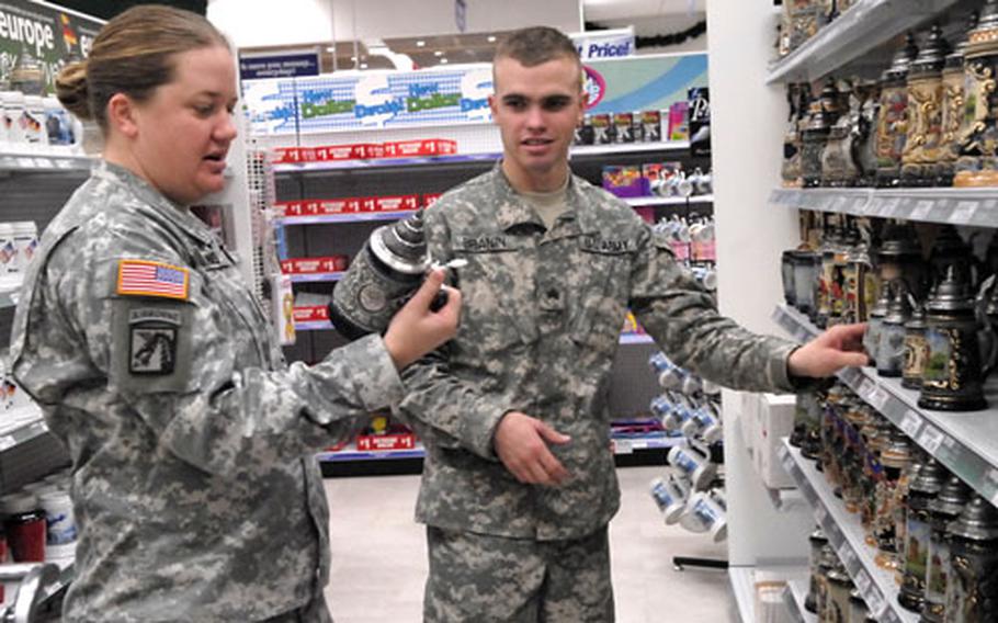 Sgt. Cody Branin, with the Utah National Guard's 115th Engineer Battalion, checks out beer steins at the post exchange in Grafenwoehr, Germany this week with Sgt. Melissa Binns, who is with the same unit. Both plan to buy most of their Christmas gifts with the Military Star Card.