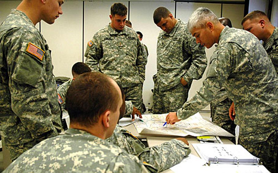 Soldiers work during a classroom training session to create a joint air and ground response to a scenario involving insurgents in a city setting. The week-long class teaches joint firepower training to help servicemembers write military missions that use both Air Force and Army equipment and weaponry.