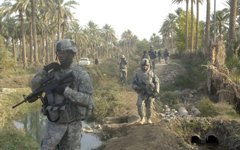 Soldiers from the 3rd Battalion, 7th Infantry Regiment, 3rd Infantry Division partol near the town of Jurf as Sakhir, south of Baghdad, earlier this month.