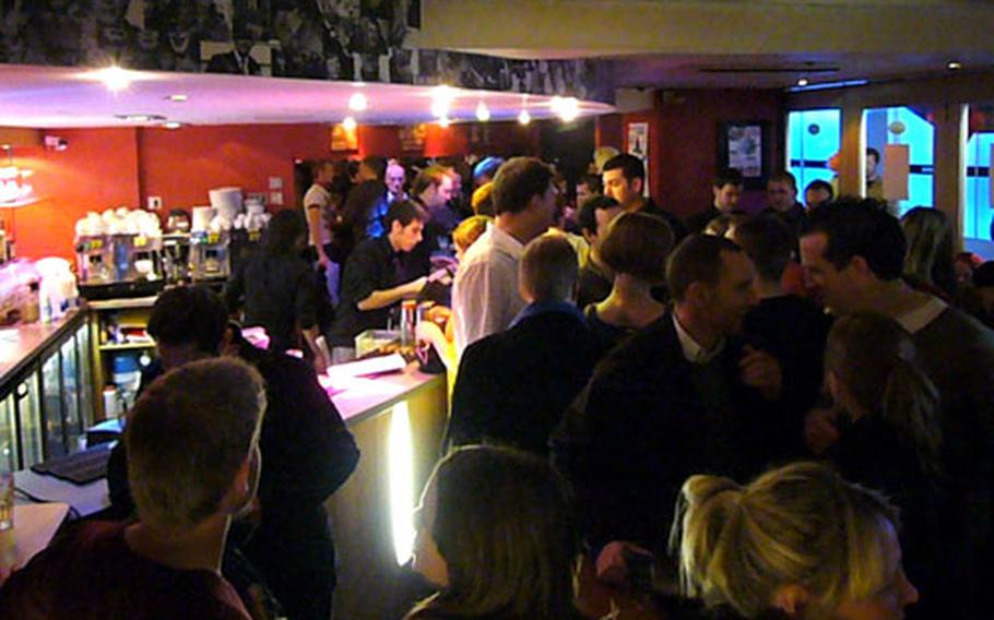 The lone bar inside Ta Bouche is surrounded by partygoers on a recent Saturday night in Cambridge.