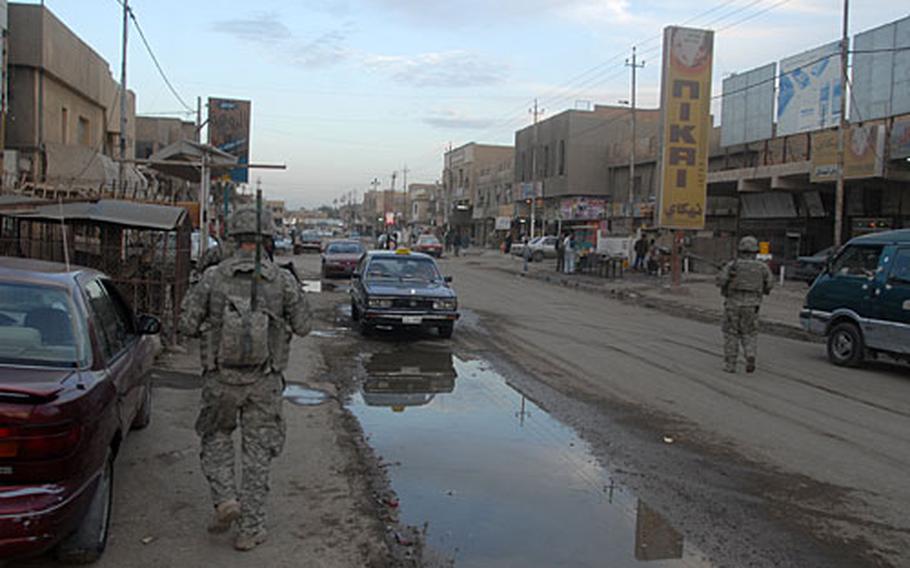 Soldiers patrol through traffic in southern Baghdad last month.