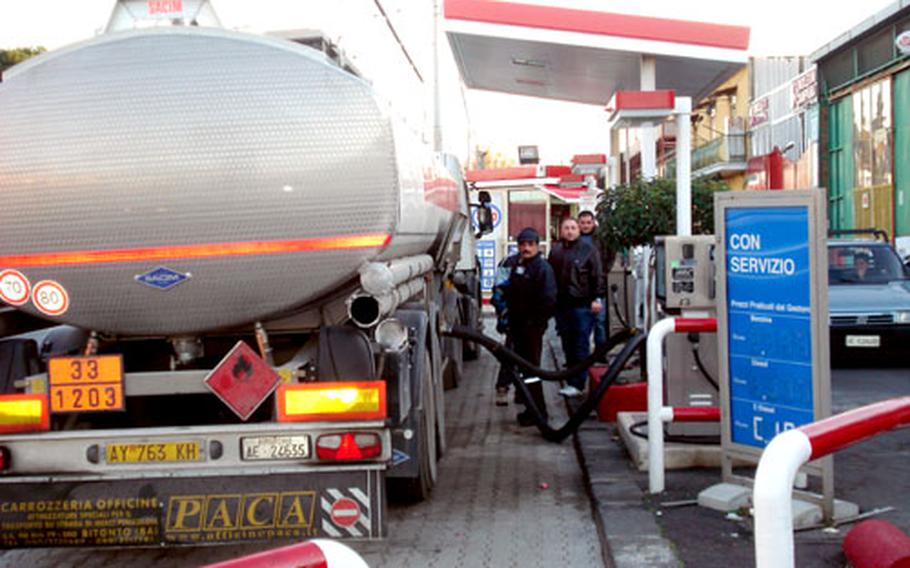 A tanker replenishes an Esso gas station Tuesday along Viale Comandante Umberto Maddalena, near the Capodichino airport and U.S. Navy base in Naples, Italy.