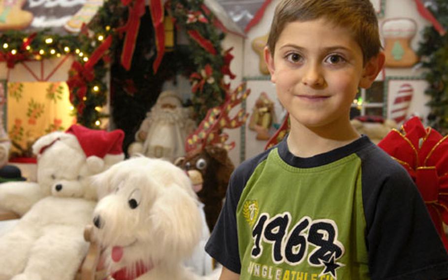 Andrew Stombaugh, an 8-year-old whose dad is a Senior Master Sergeant at Ramstein, poses for a photo at the Ramstein Community Center Thursday. Stombaugh decided to donate his birthday presents to an Army toy outreach program that ensures less-fortunate families have presents under the tree for their children.