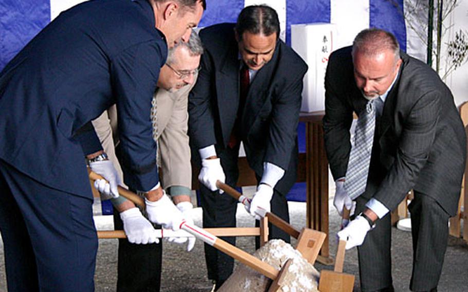 AAFES and Kadena Air Base leaders dig their ceremonial spades into the soil three times to break the ground as part of a Shinto ceremony to bless the construction site for a new exchange on Kadena.