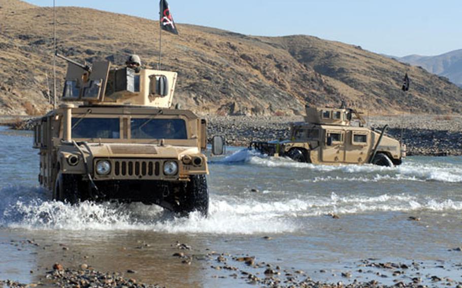 Humvees bearing members of the 4th Infantry Regiment's 3rd Platoon, Company A, 1st Battalion ford the Arghandab River in Zabul Province, Afghanistan, on Friday.