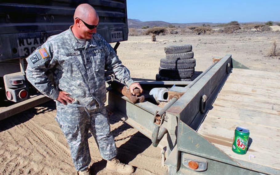Sgt. 1st Class William Brown looks at a wornout drill bit that had been used to dig a well near a remote village in southern Djibouti.