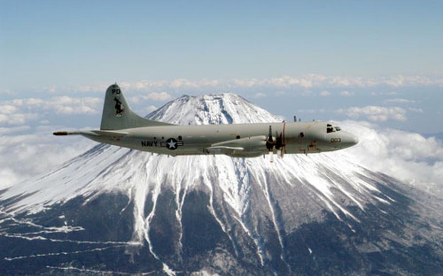 A P-3C “Orion” assigned to the “Golden Eagles” of Patrol Squadron Nine (VP-9) circles Mt. Fuji in 2003. The Navy has grounded 39 P-3C aircraft including 10 that are deployed due to “structural fatigue concerns,” Naval Air Systems Command announced Monday.
