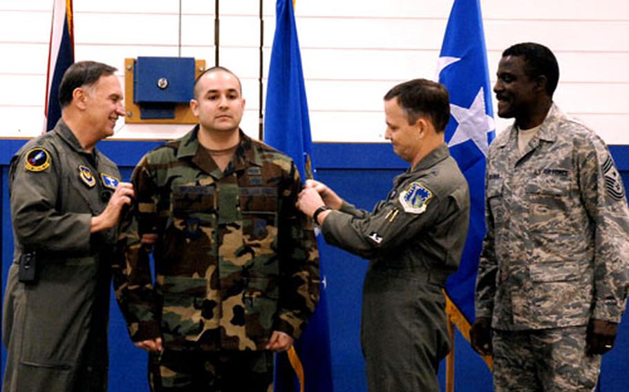 Staff Sgt. Anthony Meadows, 48th Communications Squadron, is promoted to technical sergeant by Gen. Tom Hobbins, left, then-U.S. Air Forces in Europe commander, and Brig. Gen. John Hesterman, 48th Fighter Wing commander, during Dec. 3 at RAF Lakenheath.