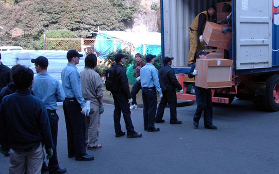 Sailors and contractors move new furniture into recently renovated single sailor quarters as part of CNFJ’s Homeport Ashore Program. The program is set to have 2,200 beds available by Christmas.