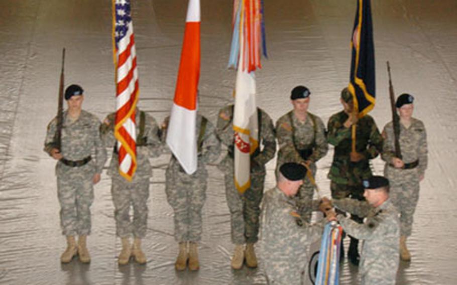 Lt. General Charles H. Jacoby (cq), I Corps commander, unfurls a flag with Command Sgt. Maj. Frank A. Grippe (cq) during a ceremony welcoming the I corps to Camp Zama, Japan, on Wednesday. I Corps from Fort Lewis, Wash., moved its forward headquarters element to Camp Zama; the transition team is the first step toward the implementation of a modernized U.S. Army command and control capability in Japan, officials said.