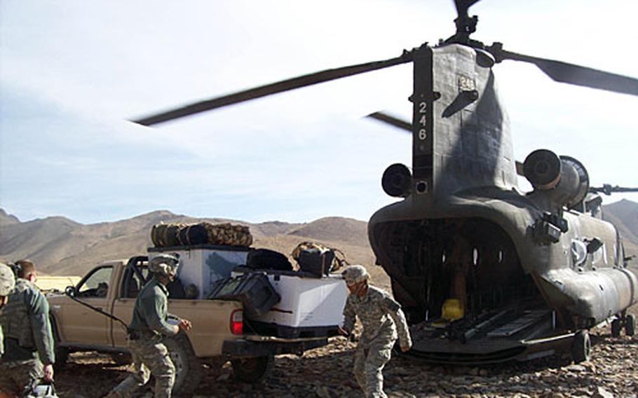 Soldiers load a Chinook helicopter at Forward Operating Base Baylough in Zabul Province, Afghanistan, on Sunday.
