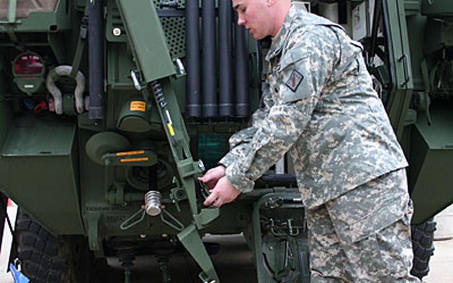 Spec. Christopher Case, an assistant surveyor with the 23rd Chemical Battalion at Fort Lewis, Wash., shows some of the chemical-sniffing sensor features built into the newest Stryker variant Nuclear, Biological Chemical Reconnaissance Vehicle.