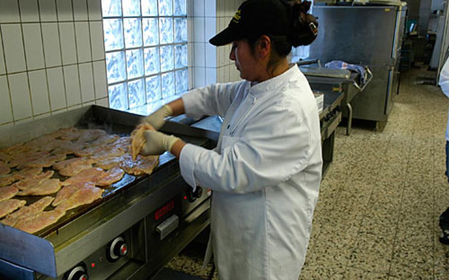 Sita Schneider, who is German, prepares lunch at the Rheinlander Convention Center in Baumholder. Schneider is one of 25 people employed by local business woman Sigrid Zimmer. Zimmer, who manages food services at the Rheinlander and also owns a downtown hotel, relies almost exclusively on the U.S. Army for her business.