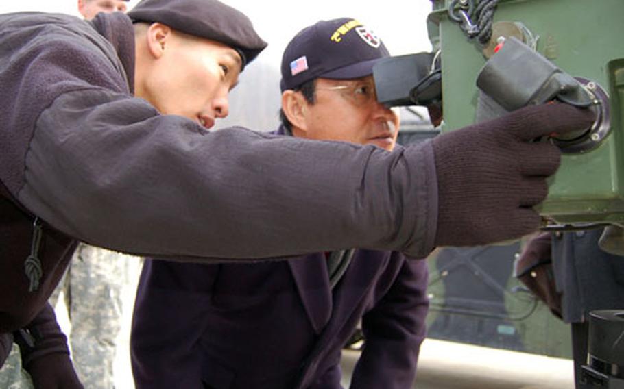 Sgt. Yoon Al-chan, 4th Squadron, 7th Cavalry Regiment, shows South Korean Minister of Foreign Affairs and Trade Song Min-soon a long range advanced scout surveillance system during the minister’s brief visit to Camp Casey, South Korea, on Friday.