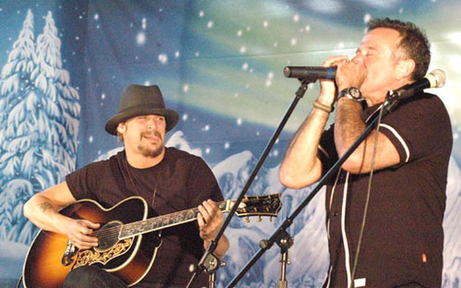 Robin Williams joined Kid Rock on stage at the end of the USO show at Aviano Air Base, Italy, in Dec. 2007 to play the harmonica and use some of his famous improvisational skills to make up lyrics to a song the two were playing.