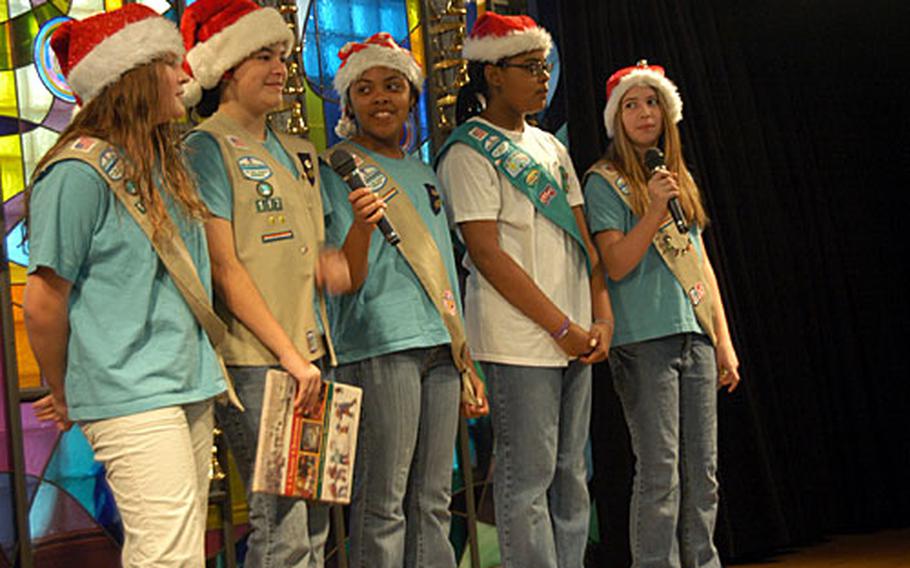 Some Yokota Girl Scouts sing carols during a Christmas party Saturday at the Yokota Home retirement facility in Fussa, Japan. About 80 base residents took part in the annual holiday exchange.