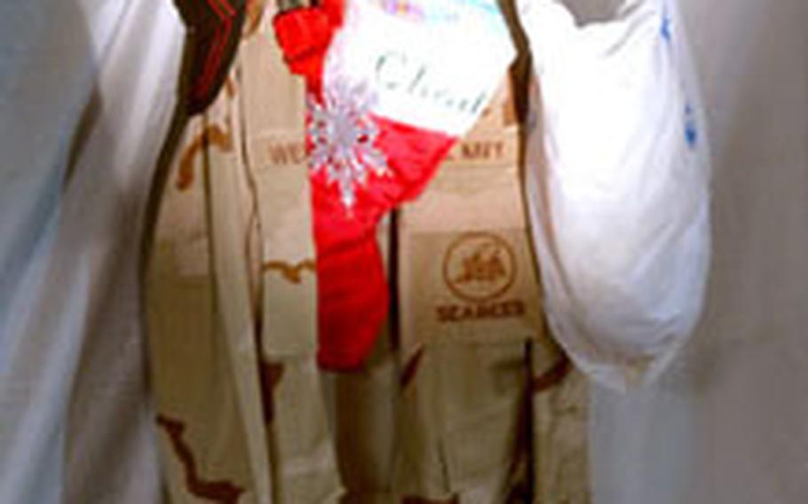 Navy Seabee Chad Wescott, 29, of Valentine, Neb., hung a Christmas stocking along with his uniform in Shant Abaq, Kenya.