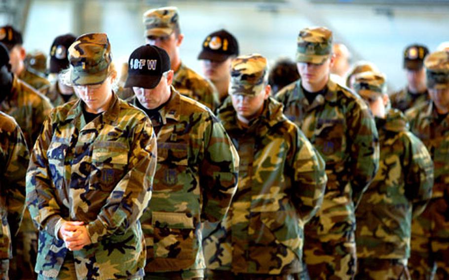 Mourners bow their heads for a prayer during a memorial ceremony for Airman 1st Class Jason D. Nathan, who died after a roadside bomb struck his vehicle in Iraq on June 23.