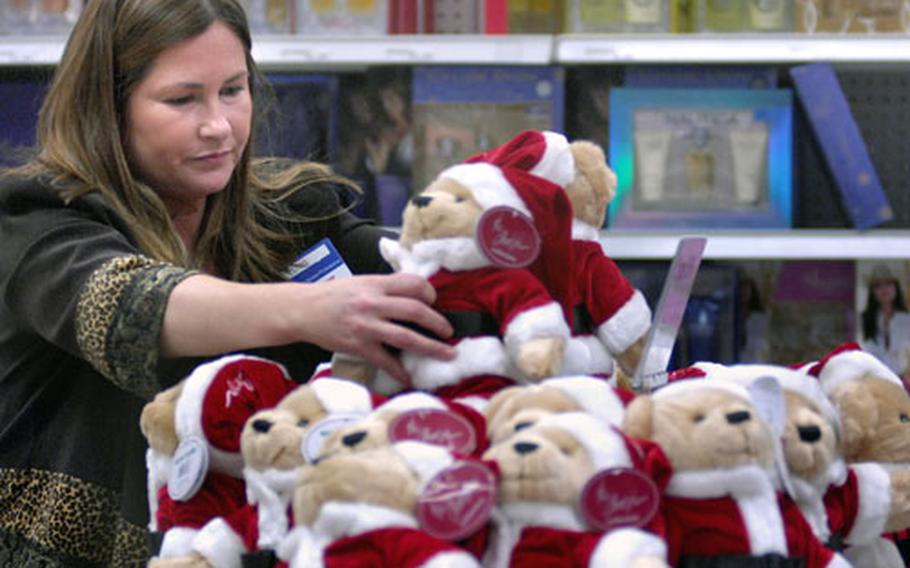 Lois Farmer, an AAFES employee, arranges discounted Christmas 2007 bears Wednesday at the Wiesbaden, Germany, PX. AAFES continues to offer Christmas-specific items at slashed prices after the holiday surge.