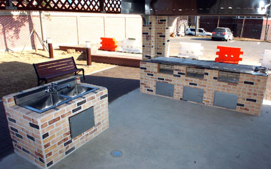 At Camp Humphreys in South Korea Wednesday, this newly built "barbecue gazebo" just inside the pedestrian gate awaits a Friday ribbon-cutting ceremony before going into use. The gazebo will allow units and organizations to hold fundraiser barbecues, selling food and beverages to troops and families. The grill is at the right.