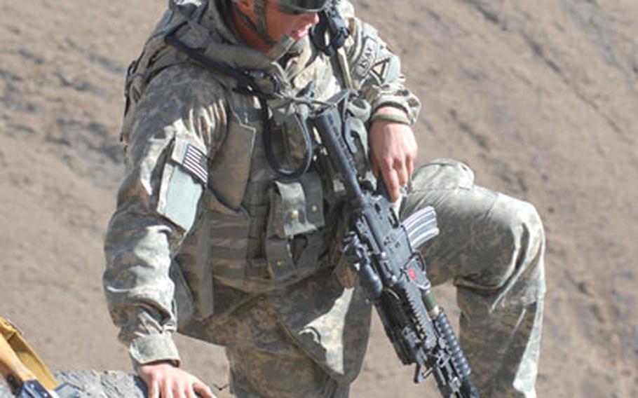 Pvt. James West, 21, of Erie, Pa. reaches the top of a steep cliff during a mountain climb in the Mizan district of southern Afghanistan's Zabul province on Friday.