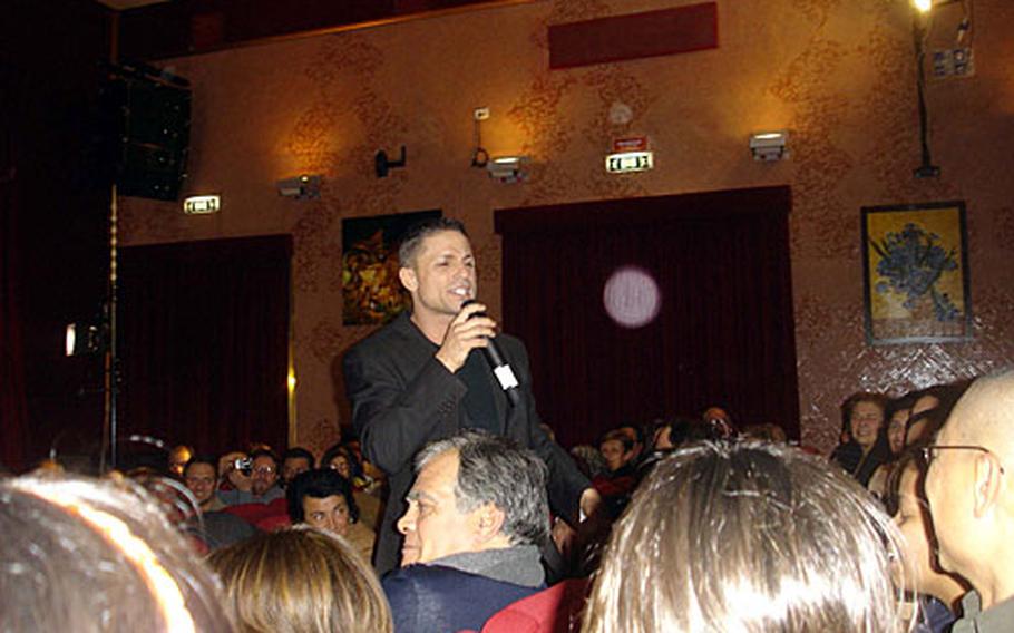Gennaro Cerulli gets personal with the audience in a number during a musical performance at Teatro Bolivar in downtown Naples, Italy on Wednesday night. Donations from the show were going to families of firefighters who died in the Sept. 11, 2001 terror attacks.