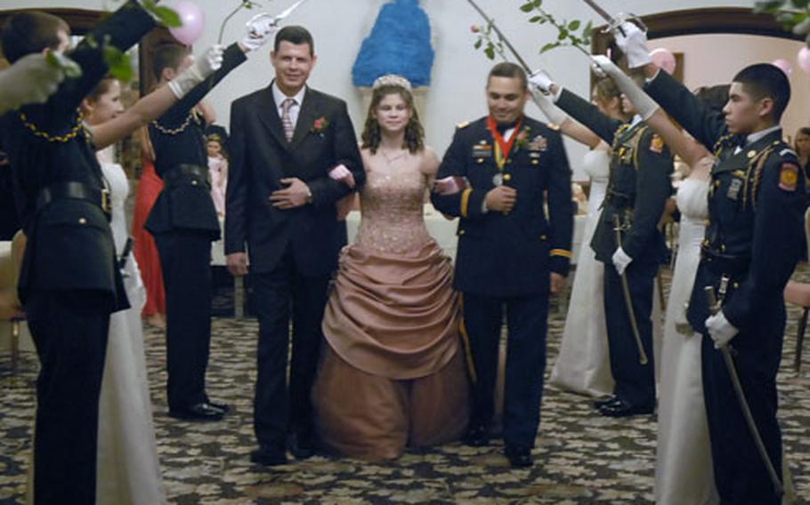 Raul Sanchez, left, his daughter, Ashley Sanchez, and her stepfather, Army Maj. Neftali Santiago, are presented to the “quinceanera,” a traditional Latino 15th birthday party for girls.