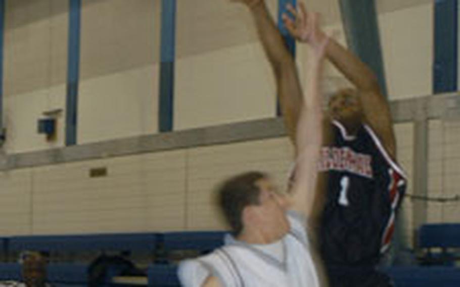 Mildenhall’s Chris Washington hits a three-pointer over tough Lakenheath defense.