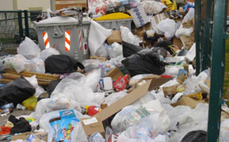 This trash collection area on the Navy Support Site at Gricignano was empty Saturday. On Thursday, it was spilling out of the enclosure.