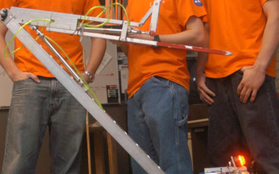 More than a dozen students from AFNORTH High School in Brunssum, Netherlands, will take part this spring in an annual high school robotics competition in Las Vegas. The 2008 team will feature several veterans, including, from left, Seth Meitzner, Zach Zembower and Brock Blankenship, pictured with last year’s entry.