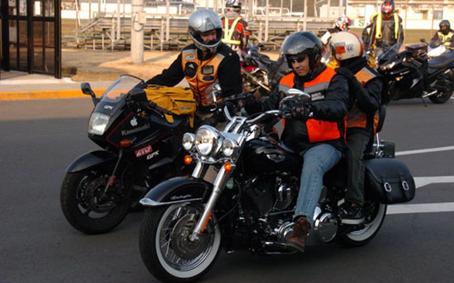 Chief Petty Officer Don Nuccino waits with Lt. Cmdr. George Wehrung and Wehrung's son William for a ride around Naval Air Facility Atsugi, Japan, after a training course at Cinema 77.