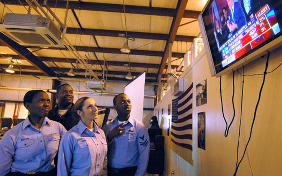 Newly arriving sailors to the aircraft carrier USS Kitty Hawk watch the New Hampshire primary returns on Wednesday.