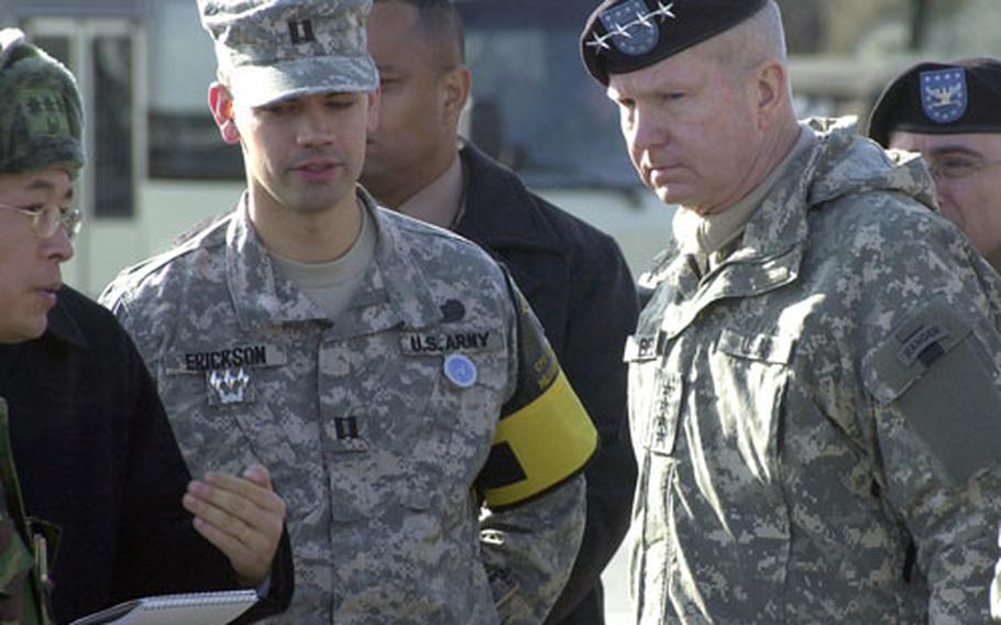 Capt. Graham Erickson, left, and U.S. Forces Korea commander Gen. B.B. Bell listen as a translator interprets for a South Korean military commander during a visit to the Eastern Transportation Corridor on Tuesday. Following the visit, Bell said Erickson illustrates the command’s push for more troops serving in South Korea with their families. Erickson, who served a year in Iraq, is now on an unaccompanied tour to South Korea, meaning another year away from his wife and 2½-year-old son.