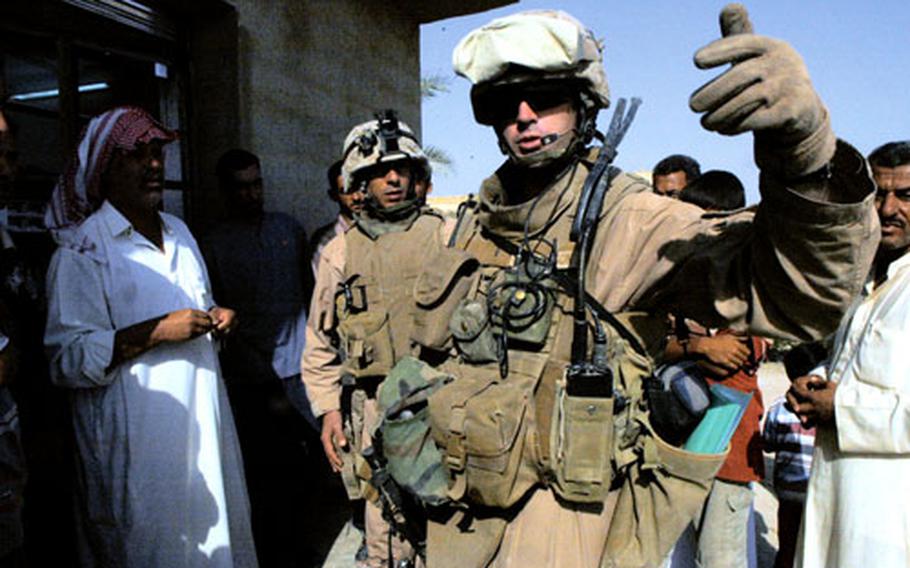 Lt. Todd Richardson, of 3rd Battalion, 3rd Marines, gets some clarification on neighborhood borders in Subayht, Iraq, in October. Anbar province was the second focus of the last year’s “surge.” Cities like Ramadi and Hit were brought under of control since it began.