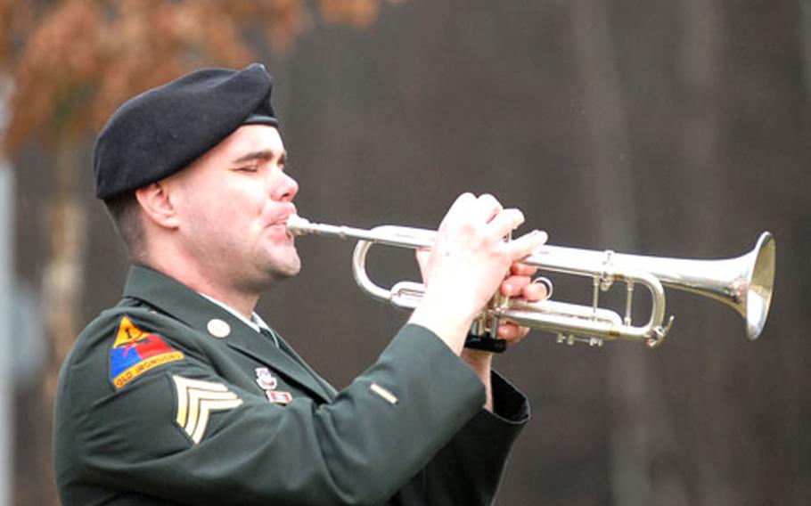 Sgt. Joseph Goins of the Mannheim, Germany-based 76th Army Band plays taps at the conclusion of the memorial ceremony for Sgt. 1st Class Matthew Pionk, Staff Sgt. Sean Gaul, Staff Sgt.