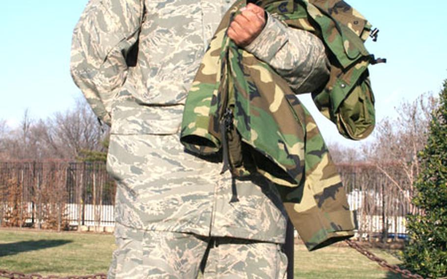 Tech. Sgt. Cohen Young, an Air Force photographer stationed at the Pentagon, wears the All Purpose Environmental Clothing System (APECS) jacket. The jacket is in such short supply that service officials have authorized airmen wearing the new Airman Battle Uniform to also wear the woodland-patterned camouflage Gore-Tex coat (seen across his arm).