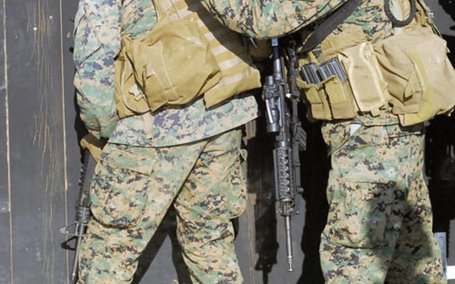 FAST Company Marines get ready to storm through a shoothouse door at Hohenfels' "The Box" training area on Thursday.