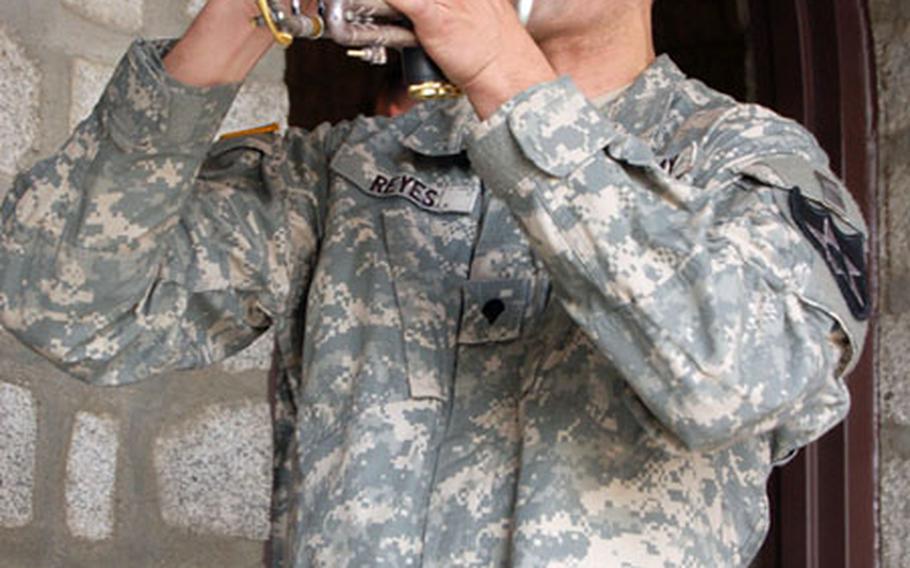 Spc. Juan Reyes plays taps at Camp Red Cloud’s Warrior Chapel on Friday during a memorial service for Spc. Armando Matos Chamorro. The soldier died in December while on vacation in Norway.