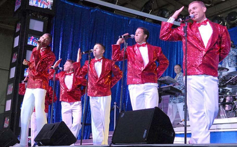 Led by Senior Airman Tyrece Robertson, left, Tops in Blue male vocalists senior airmen Rick Rosales and Benjamin Taylor, Airman 1st Class Jesse Cox and Senior Airman Nicholas Amari sing a soul number during the group's performance in Ramstein, Germany, Sept. 25, 2007. Tops in Blue's lineup for its upcoming tour includes airmen from Spangdahlem and Aviano air bases and Lajes Field. The group is also seeking more help in a few categories, such as the horn section, technicians and drivers.