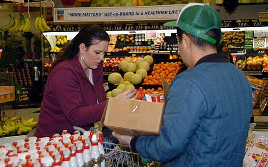 Katie McNett, a dependent on Yokota Air Base shops in the commissary for items found on base that are lower priced than off base .