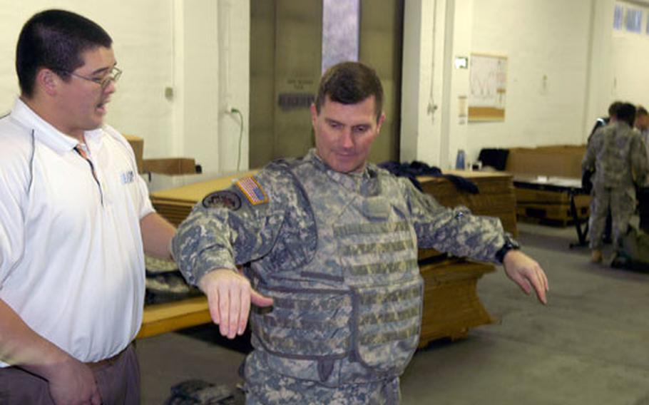 First Sgt. Michael Morton of the 1st Battalion, 6th Infantry in Baumholder tests the flexibility of the Improved Outer Tactical Vest, which the 2nd Brigade, 1st Armored Division is being issued before its upcoming deployment to Iraq.