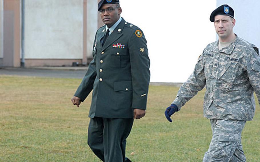 Spc. Loren Barrett, left, is escorted to court Tuesday in Vilseck, Germany.