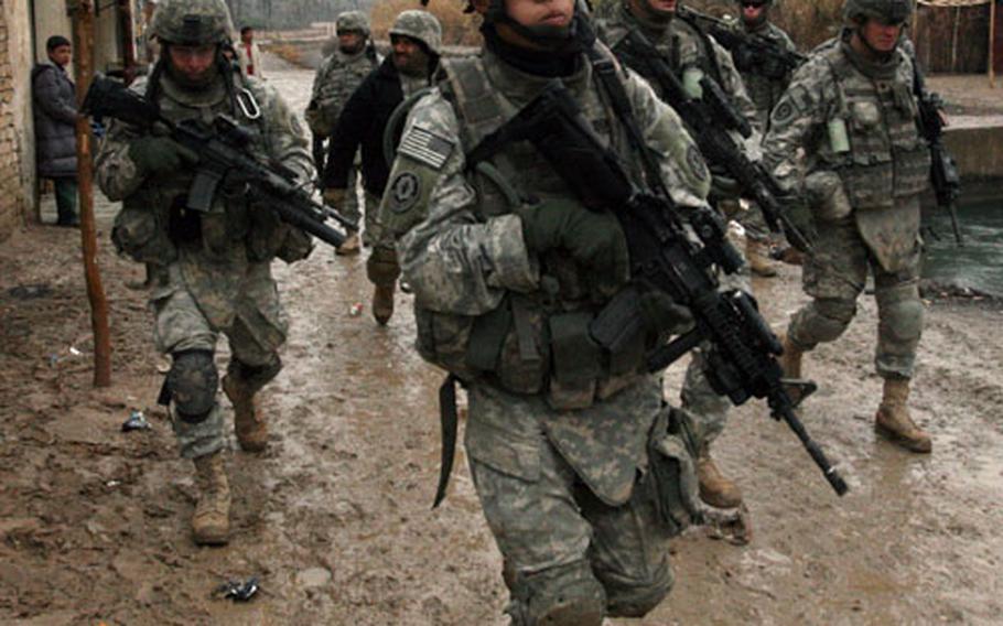 U.S. soldiers with 3rd Squadron, 2nd Cavalry (Stryker) Regiment patrol a village near Muqdadiyah. Lt. Col. Rod Coffey, the squadron commander, has said that he believes 80 to 90 more insurgents may be at large and has ordered a lockdown on four main villages.