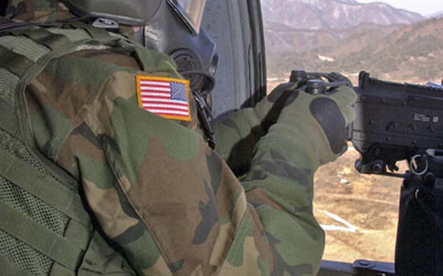 Pfc. Frank Pinguelo, of the 2nd Battalion, 2nd Aviation Regiment, attacks targets from a Black Hawk helicopter Thursday at Rodriguez Range, South Korea. Black Hawk, Chinook and Apache helicopter gunners all had their chance to fire last week at the 2nd Combat Aviation Brigade's gunnery practice. The aviators also trained for ground convoy operations.