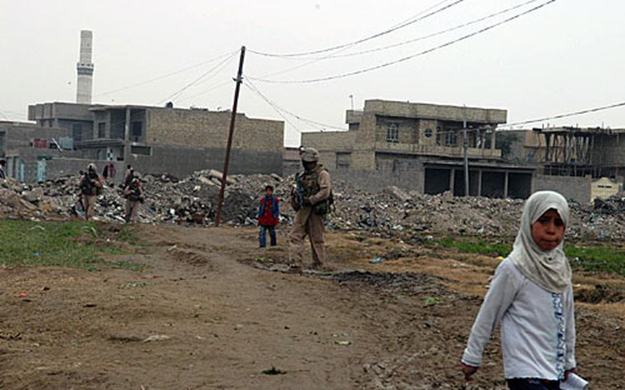 Marines with 3rd Squad, 4th Platoon, Company K, 3rd Battalion, 4th Marines patrol their area of Fallujah on Saturday afternoon. These Marines have seen their latest deployment go from combat to civil affairs-style work.
